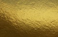 Gold foil texture background with uneven surface Royalty Free Stock Photo