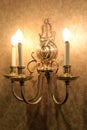 Gold foil wallpaper with beautiful candle-like lighting fixture