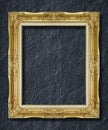 Gold frame on black slate background Royalty Free Stock Photo