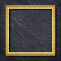 A gold frame on Dark grey black slate background or texture Royalty Free Stock Photo