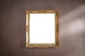 Gold frame on dark wood wall