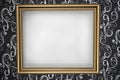 Gold frame with a white background on the wall wit