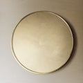 Gold framed mirror on a brown wall Royalty Free Stock Photo