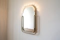 Gold framed mirror with lights on wall image Royalty Free Stock Photo