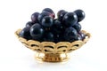 Gold fruit dish with black gra Royalty Free Stock Photo