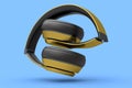 Gold gaming headphones and concept of music equipment isolated on blue .