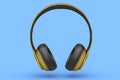 Gold gaming headphones and concept of music equipment isolated on blue .