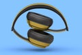 Gold gaming headphones and concept of music equipment isolated on blue .