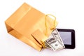 Gold gift bag with a Tablet and dollars Royalty Free Stock Photo