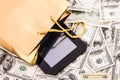 Gold gift bag with a Tablet and dollars Royalty Free Stock Photo