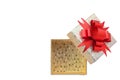 Gold gift box with red bow on white background Royalty Free Stock Photo