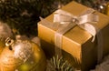 Gold gift box with silver bow, toy balls Royalty Free Stock Photo