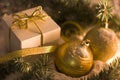 Gold gift box with silver bow, toy balls Royalty Free Stock Photo