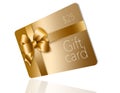 A gold gift card with a gold bow and ribbon is pictured here isolated on the background Royalty Free Stock Photo