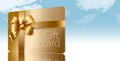 A gold gift card with a gold bow and ribbon is pictured here isolated on the background Royalty Free Stock Photo