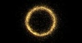 Gold glitter circle with glittering light shine sparkles frame on black background for Christmas holiday. Abstract magic glow of