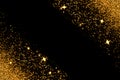 Gold glitter with glowing sparks on black background