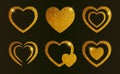 Gold glitter hearts set. Vector romantic shiny icons with sparkles for valentine's day isolated on black background