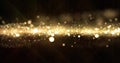 Gold glitter, light wave particles shine bokeh effect on black background. Shining gold sparks and glittering sparkling light, Royalty Free Stock Photo