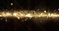 Gold glitter, light wave particles shine bokeh effect on black background. Shining gold sparks and glittering sparkling light glow Royalty Free Stock Photo