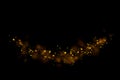 Gold glitter particles lights trail and bokeh on a black background. Abstract line sparkle texture Royalty Free Stock Photo