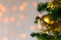 Gold glitter robin on Christmas tree. Copy space. Royalty Free Stock Photo