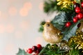 Gold glitter robin on Christmas tree. Copy space. Royalty Free Stock Photo