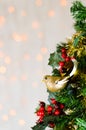 Gold glitter robin on Christmas tree. Copy space. Royalty Free Stock Photo