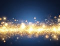Gold glitter sparkle lights on blue background. Festive, celebration concept. Royalty Free Stock Photo