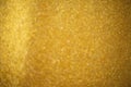 Gold glitter sparkles with bokeh effect. Festive background with bright golden lights. Christmas mood concept. Copy space texture Royalty Free Stock Photo