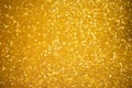 Gold glitter sparkles with bokeh effect. Festive background with bright golden lights. Christmas mood concept. Copy space texture Royalty Free Stock Photo