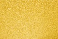 Gold glitter texture background. Yellow golden sparkle lights. Selective focus