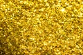 Gold glitter texture. Festive sparkling sequins background. Wpaper for Valentine, New Year or Christmas Holidays.