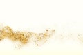 Gold glitter texture on a milky background. Abstract golden colored particles, flow of wavy shiny confetti. Festive