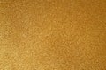 Gold glitter texture sparkling paper background. Abstract twinkled golden glittering background with bokeh, defocused lights for