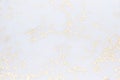 Gold glitter on white background as modern festive abstract backdrop.