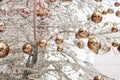 Gold glossy Christmas balls on a white glass Christmas tree. Royalty Free Stock Photo