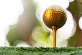 Gold golf ball and pins with a bright light, the ultimate victory of golf