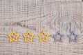 Gold, gray, silver five stars shape on wooden background. The best excellent business services rating customer experience concept Royalty Free Stock Photo