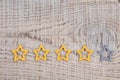 Gold, gray, silver five stars shape on wooden background. The best excellent business services rating customer experience concept Royalty Free Stock Photo