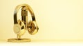 Gold headphones and microphone with copy space