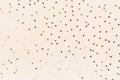 Gold heart confetti on pastel champagne color background. Festive romantic holiday backdrop