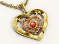 Gold heart necklace decorated with ruby gemstones. 3D illustration Royalty Free Stock Photo