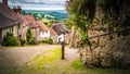 Famous Gold Hill cobbled street with thatched roof houses in Shaftesbury, UK Royalty Free Stock Photo