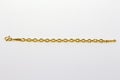 Gold hoop bracelet on a white background