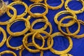 Gold, Indian, women`s handmade bracelets on blue background.