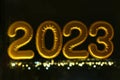 Gold inflatable foil balloons numbers 2023 on the window against the background the night city, in neon light. New year Royalty Free Stock Photo