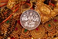 gold jewelery IN wooden Durga, Saraswati or laxmi silver coin isolated on white background . indiaan god