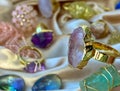 Gold jewelry colorful gemstone rings on silk blue green lilac pink color