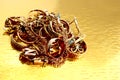 Gold jewelry, folded pile on a gold background